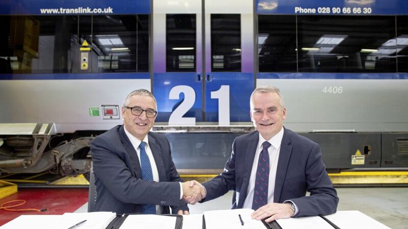 Translink Group chief executive Chris Conway (right) and Josu Esnaola, group commercial director at CAF, sign a contract for 21 new train carriages for NI Railways 