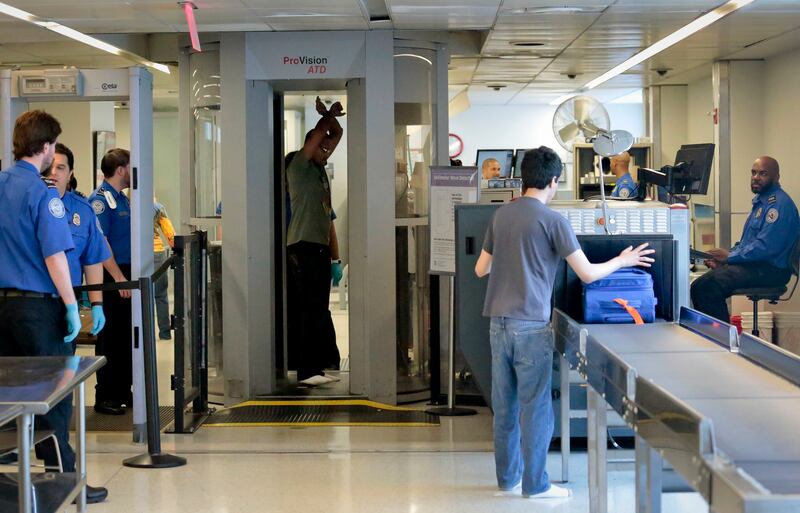 Passengers being screened at LaGuardia Airport in New York, where officers found bullets in a nappy (Bebeto Matthews/AP)