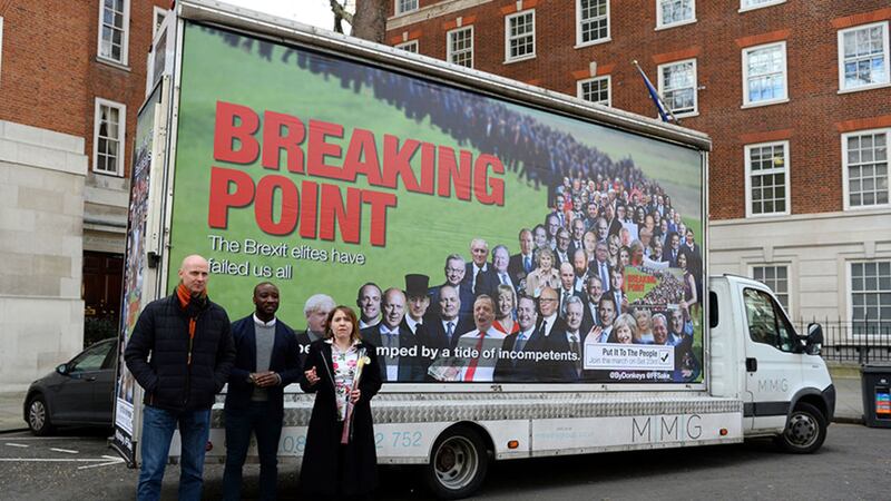 An anti-Brexit billboard featuring Brexit supporters is unveiled in Smith Square, Westminster, by (left to right) Remainer Now campaigner Hugh Norris, For our Future's Sake presenter Jason Arthur, and Remainer Now campaigner Emma Knuckey&nbsp;
