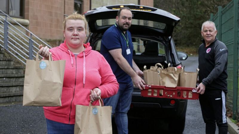 Geraldine McTasney and Paul McCusker (left) from The People&#39;s Kitchen, Belfast and and Kevin McVeagh, from Cumann Sp&oacute;irt An Phobail, help deliver more than 400 meals across the city yesterday. Picture Mal McCann. 