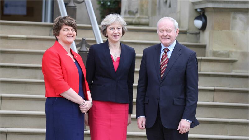 Prime Minister Theresa May with the First Minister Arlene Foster and Deputy First Minister Martin McGuinness at Stormont. Picture by Hugh Russell&nbsp;