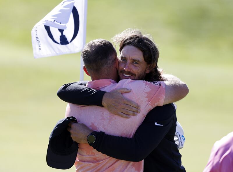 Tommy Fleetwood share a hug with Tyrrell Hatton on the 18th green after a practice round ahead of The Open Championship at Royal Liverpool. Picture by PA