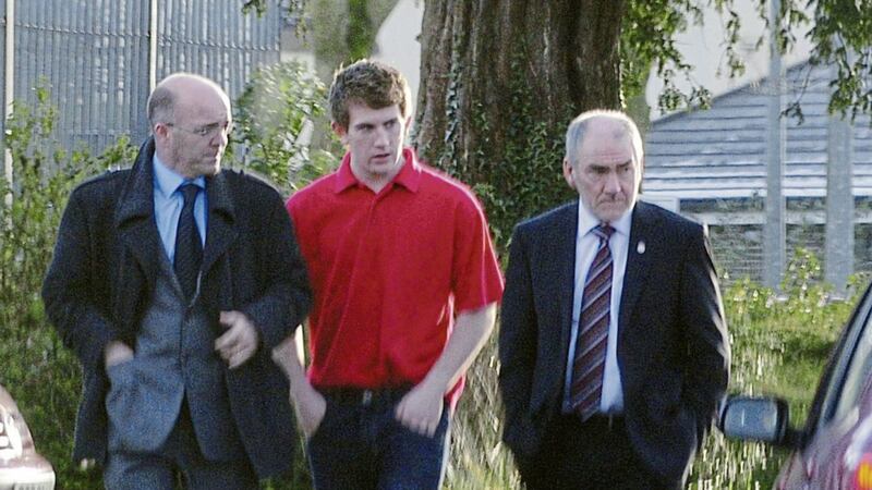 Sean Hackett pictured with Tyrone football manager Mickey Harte and and his solicitor in 2013 