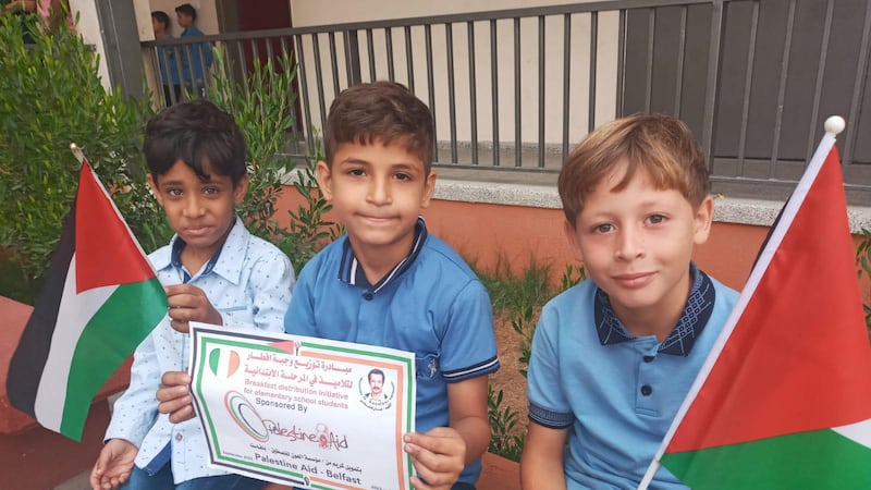 Children in Gaza pictured with a certificate acknowledging a donationa from Palestine Aid Belfast.
