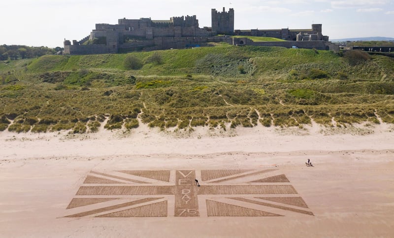 A giant Union flag was drawn in the sand on the beach beneath Bamburgh Castle in Northumberland by maintenance manager Andrew Heeley, 56
