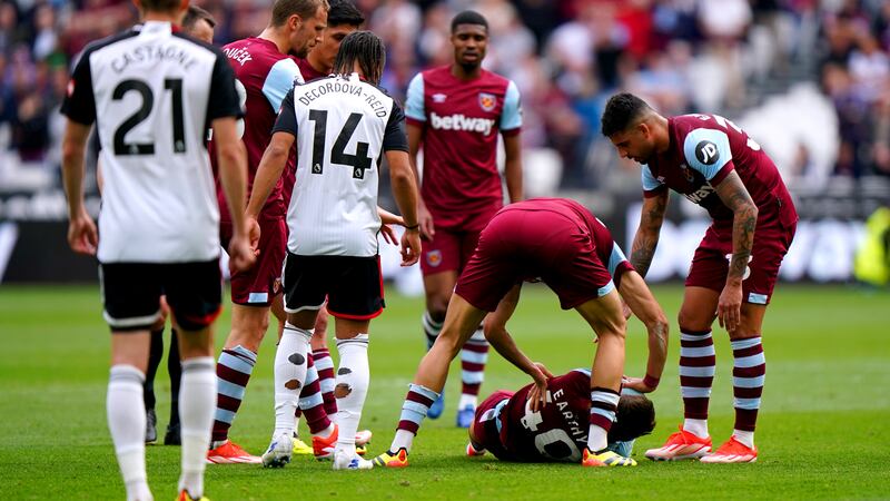 West Ham players come to the aid of team-mate George Earthy as he lies injured