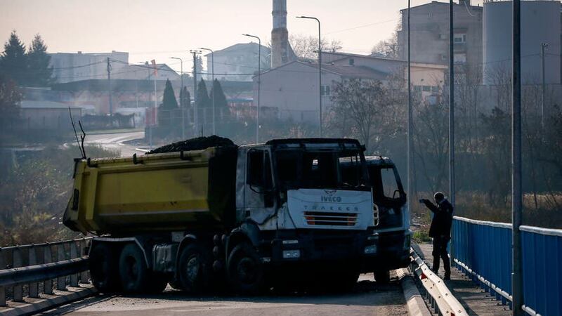 A burnt-out truck is part of a barricade on the bridge near the northern, Serb-dominated part of Mitrovica, Kosovo (Visar Kryeziu/AP)