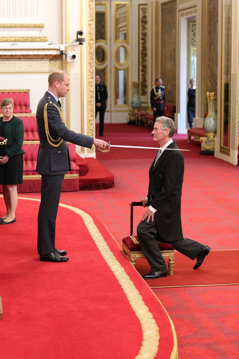 Sir Michael Palin being knighted