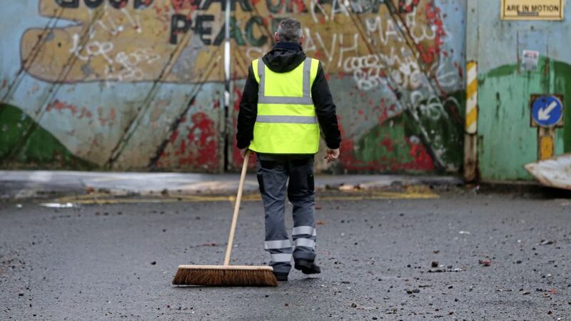 &nbsp;The clean up begins at the peace gates in Lanark Way in west Belfast after a night of rioting. Picture by Mal McCann