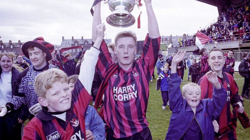 Flashback 1997: Crusaders win the Irish Premier league title on April 19 1997 with a 0-0 draw at home to Coleraine. Striker Glenn Hunter celebrates with the Gibson Cup and Crues fans at the final whistle. Picture by Pacemaker 