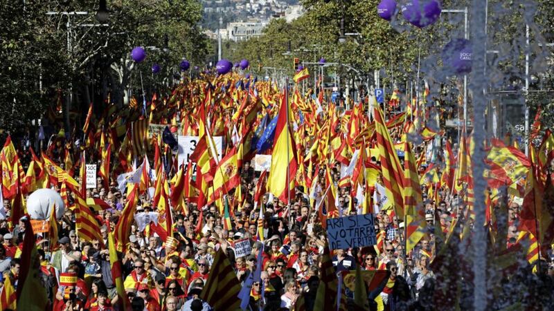 Activists march with Catalan, Spanish and European Union flags during a mass rally against Catalonia&#39;s declaration of independence, in Barcelona Emilio Morenatti/AP) 