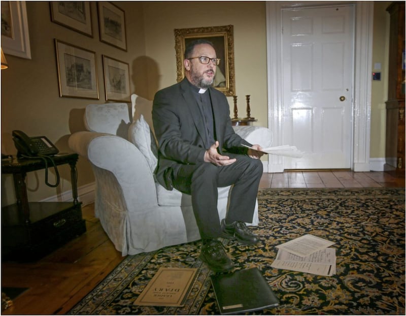 Fr Eugene O&#39;Neill, Administrator of St Patrick&#39;s Church in Belfast, looks through letters sent to the church by artist John Lavery. Picture: Hugh Russell 