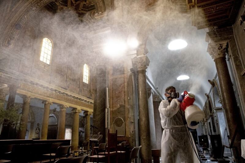 A man sprays disinfectant as he cleans inside Santa Maria in Trastevere Basilica in Rome. Picture by AP Photo/Alessandra Tarantino 