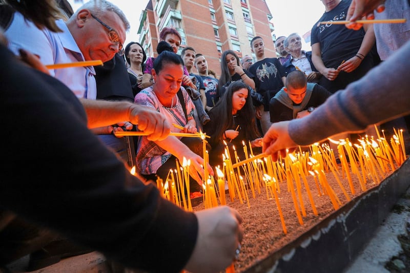 People light candles for the three killed Serbs in northern Serb-dominated part of ethnically divided town of Mitrovica, Kosovo