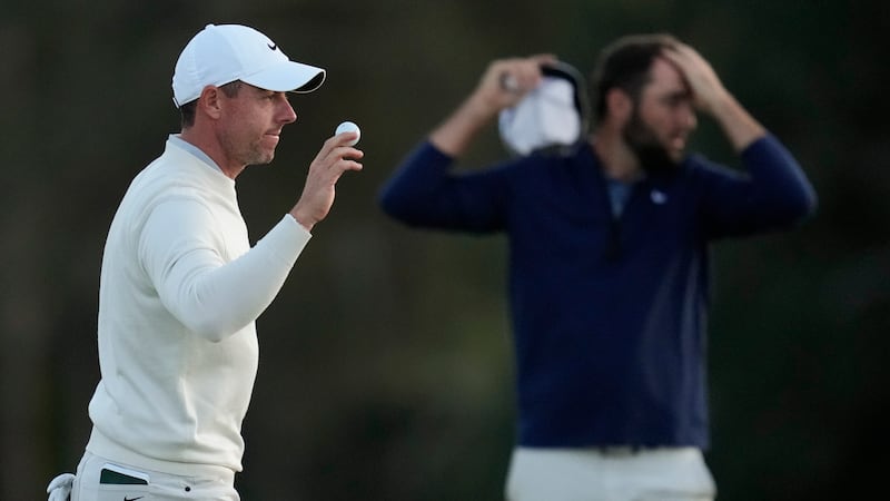 Rory McIlroy (left) trailed Scottie Scheffler (background) by 10 shots at the halfway stage of the Masters (Ashley Landis/AP)