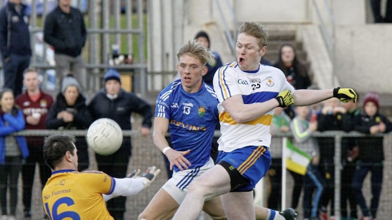 Coalisland&#39;s Peter Donnelly saves this shot from Errigal&#39;s Stefan Tierney with Bailey Leonard looking on. 