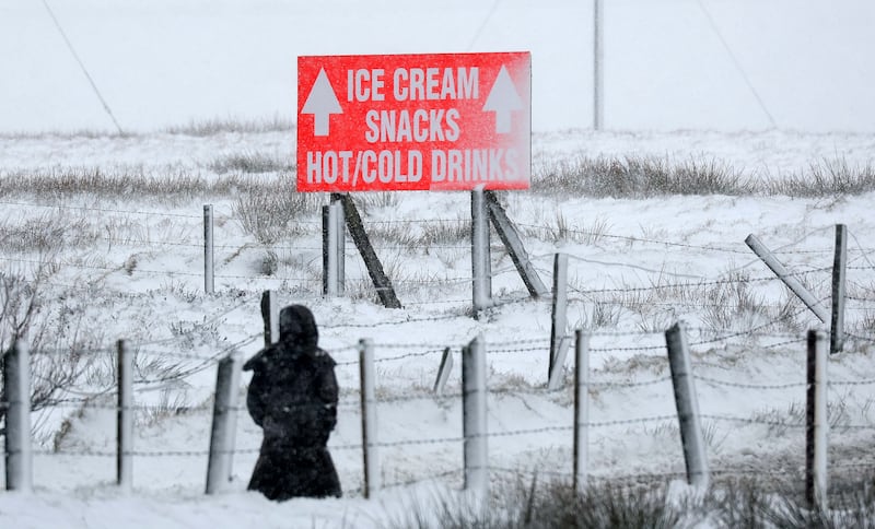 Hot or Cold…… A Women battles threw the snow on Divis Mountain with snow falls across Ireland.
PICTURE: COLM LENAGHAN