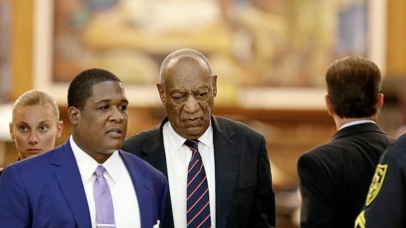Andrew Wyatt, left, leads Bill Cosby, center, as they leave the Montgomery County Courthouse during Cosby&#39;s sexual assault trial Picture: David Maialetti/The Philadelphia Inquirer via AP 