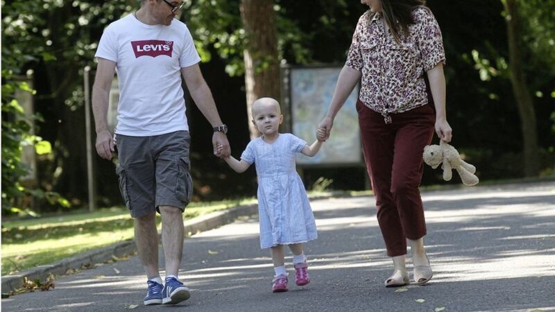Ellen Treanor (3), who is battling stage 4 high-risk neuroblastoma, with parents Claire and Paddy. Picture by Hugh Russell 
