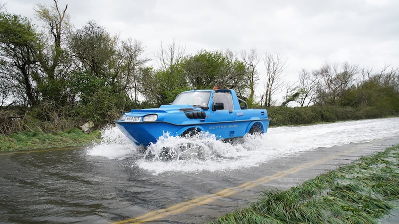 A car drives through flood water in Littlehampton, West Sussex