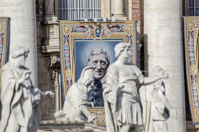 A tapestry portraying Cardinal John Henry Newman hangs from the facade of St Peter&#39;s Basilica at the Vatican on Sunday. Picture by AP Photo/Alessandra Tarantino 