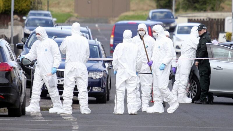Forensic officers carry out a fingertip search at the scene of the shooting of loyalist Geordie Gilmore in Carrickfergus. Picture by Mal McCann. 