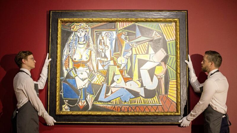Gallery staff at Christie&#39;s London showroom hanging Les femmes d&#39;Alger (version O) by Pablo Picasso. Picture by Dominic Lipinski, Press Association 