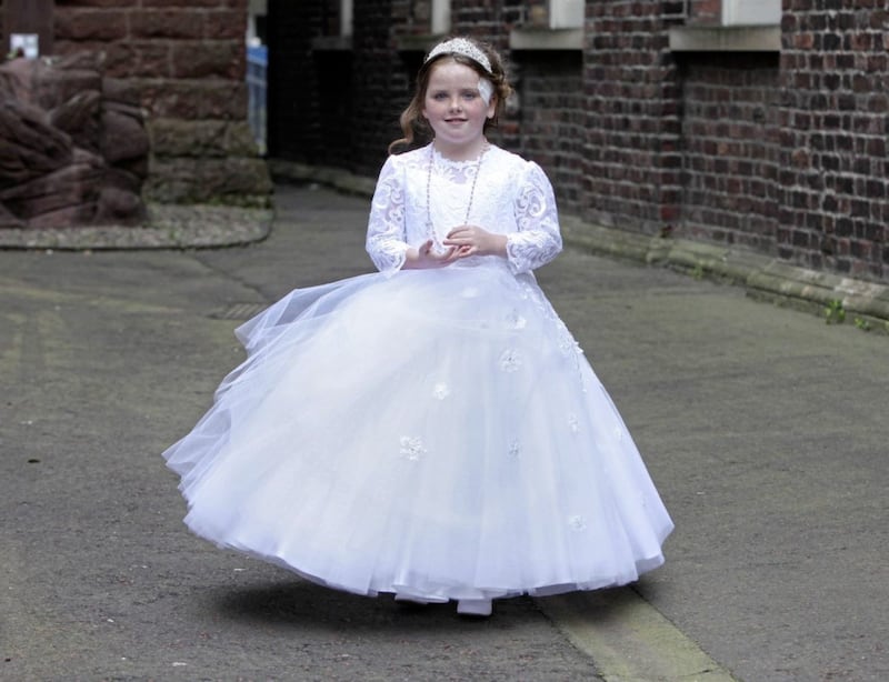 Annie McFadden (8) made her First Holy Communion at St Patrick&#39;s Church in Belfast yesterday, a week after she suffered a catalogue of injuries when she was attacked by a dog in north Belfast. Picture: Ann McManus 