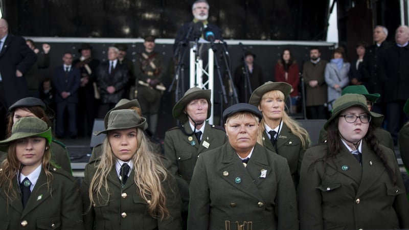Women dressed in period uniform listen to Sinn Fein President Gerry Adams TD speak during the Sinn Fein commemoration marking the 1916 Easter Rising centenary commemorations at Milltown Cemetery, Belfast. Picture by Liam McBurney, Press Association