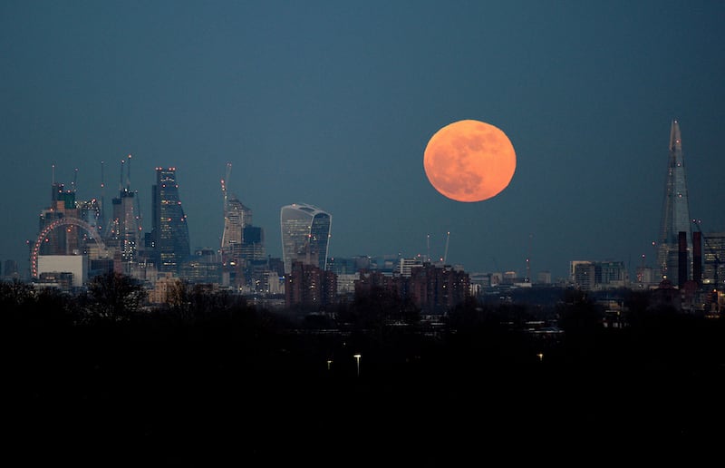 The moon rises over the London skyline (Kirsty O'Connor/PA)