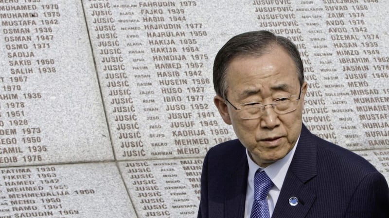 Former UN Secretary General Ban Ki-moon walks in front of a memorial stone inscribed with names of people killed in the Srebrenica massacre in 2012 