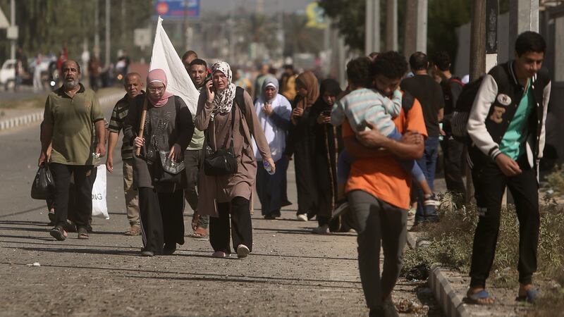 Palestinians flee Gaza City to the southern Gaza Strip on Salah al-Din street in Bureij (AP)