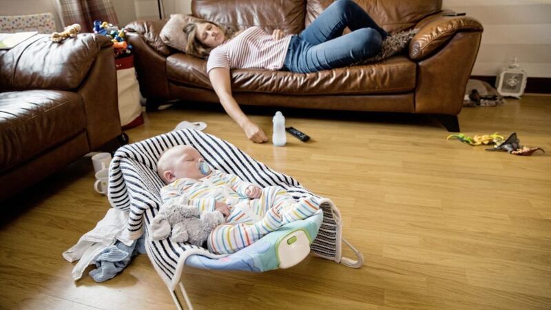 Mum naps while her newborn is sleeping. but is she thinking about insuring her child? 
