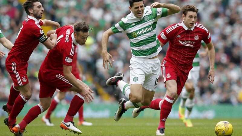 Celtic's Tom Rogic and Aberdeen's (from left) Graeme Shinnie, Andrew Considine and Ash Taylor battle for the ball during the Ladbrokes Scottish Premiership match at Celtic Park&nbsp;