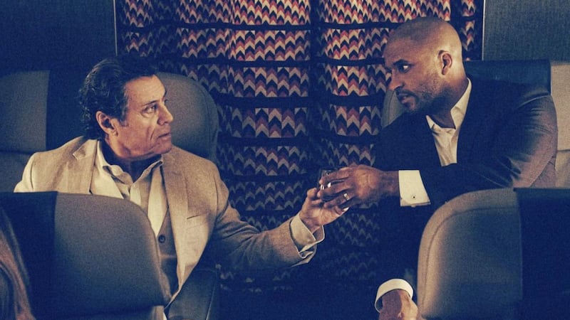 Mr Wednesday (Ian McShane) and Shadow (Ricky Whittle) toast the beginning of a highly unconventional relationship in American Gods 