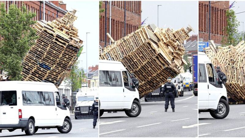 Police and contractors move into Cluan Place in east Belfast to remove a loyalist bonfire from the road. Picture Mal McCann. 