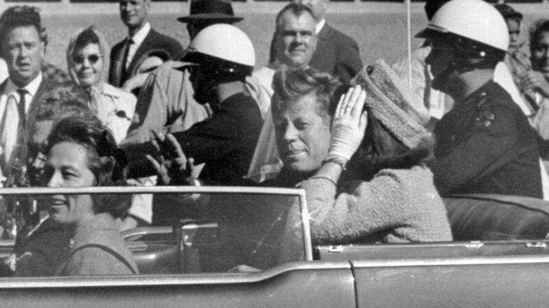 President John F Kennedy waves from his car in a motorcade in Dallas on November 22, 1963, just before his assassination. Riding with Kennedy are First Lady Jacqueline Kennedy, right, Nellie Connally, second from left, and her husband, Texas Governor John Connally, far left. Picture by Associated Press&nbsp;
