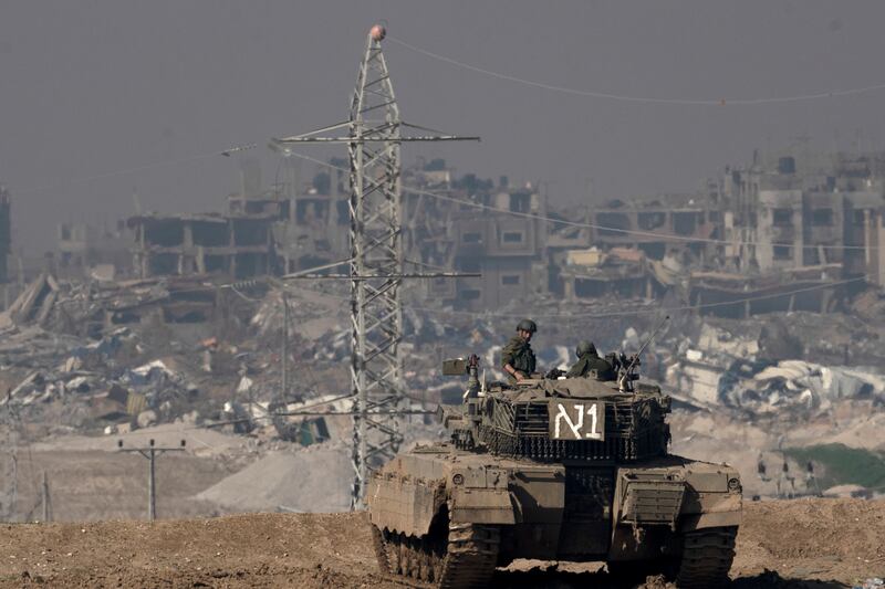Israeli soldiers overlook the Gaza Strip from a tank, as seen from southern Israel on Friday (Maya Alleruzzo/AP)