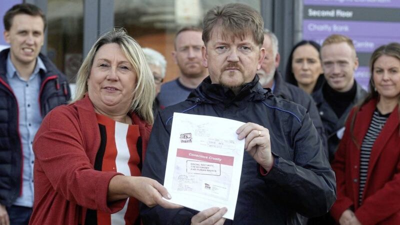 Tom McWilliams and Kirsty Scott with a copy of the report which they handed in to Department for Communities permanent secretary Leo O&#39;Reilly in Belfast. Picture by Hugh Russell 