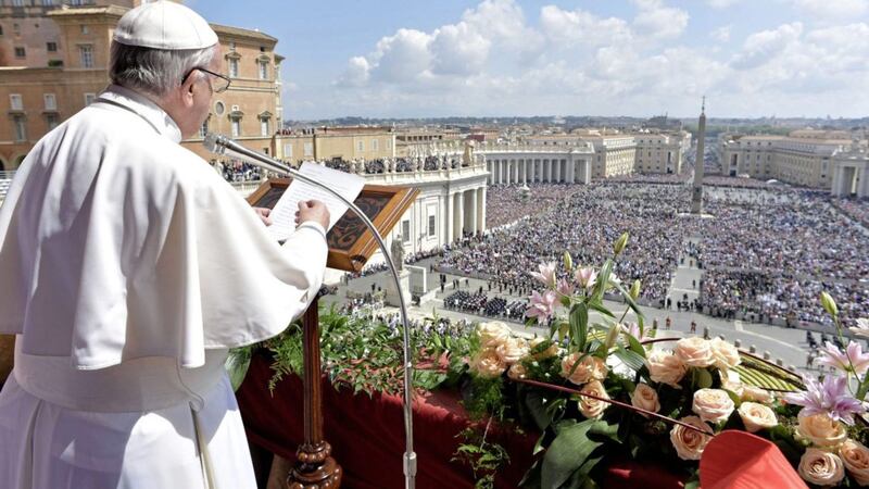 Pope Francis delivers his Urbi et Orbi (to the city and to the world) message from the main balcony of St. Peter&#39;s Basilica, at the Vatican L&#39;Osservatore Romano/Pool Photo via AP 