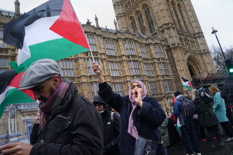 People take part in a Palestine Solidarity Campaign rally outside the Houses of Parliament, London, as MPs debate calls for a ceasefire in Gaza