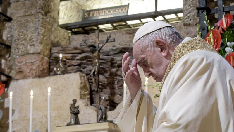 Pope Francis, pictured praying on Saturday at the tomb of St Francis of Assisi, where he signed his new encyclical. Picture by Vatican Media via AP 