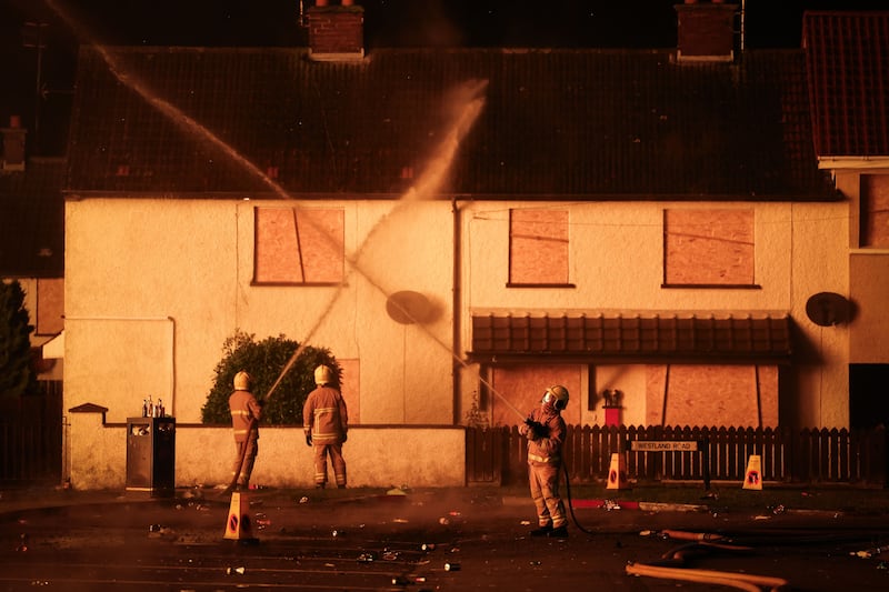 Members of the Northern Ireland Fire and Rescue Service dampened down local homes with water in the Westland Drive are of Corcrain. Picture by by Kelvin Boyes / Press Eye