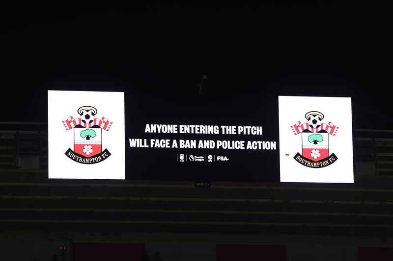 The large stadium screen warning fans to stay in their seats