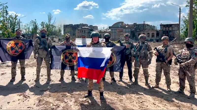 Yevgeny Prigozhin, the head of the Wagner Group military company, holds a Russian national flag in front of his soldiers in Bakhmut (Prigozhin Press Service via AP/PA)