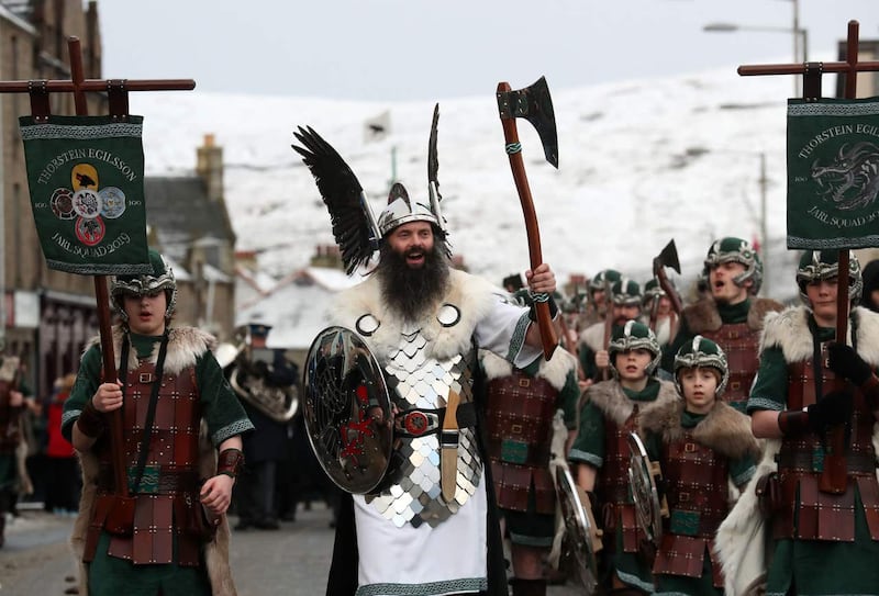 Guizer Jarl John Nicolson cheers whilst marching through Lerwick on the Shetland Isles during the Up Helly Aa Viking festival