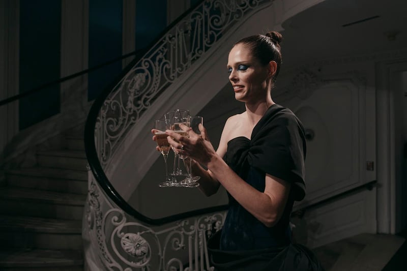 Canadian fashion model Coco Rocha carries drinks before the show starts