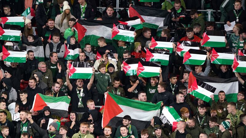 Celtic fans in the stands hold up flags of Palestine (Andrew Milligan/PA)