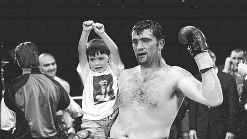 Darren Corbett holds his son Darren Jnr after retaining his Commonwealth cruiserweight title at Maysfield leisure centre in Belfast in December 1997 