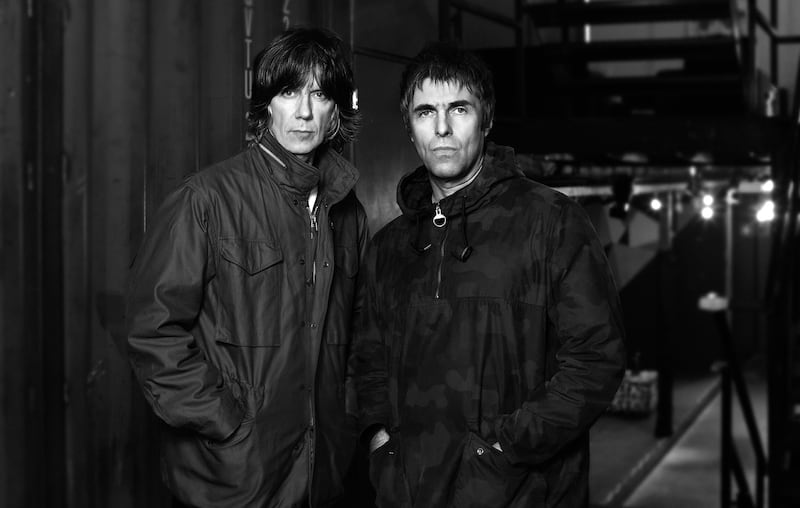 A black and white photo of John Squire and Liam Gallagher